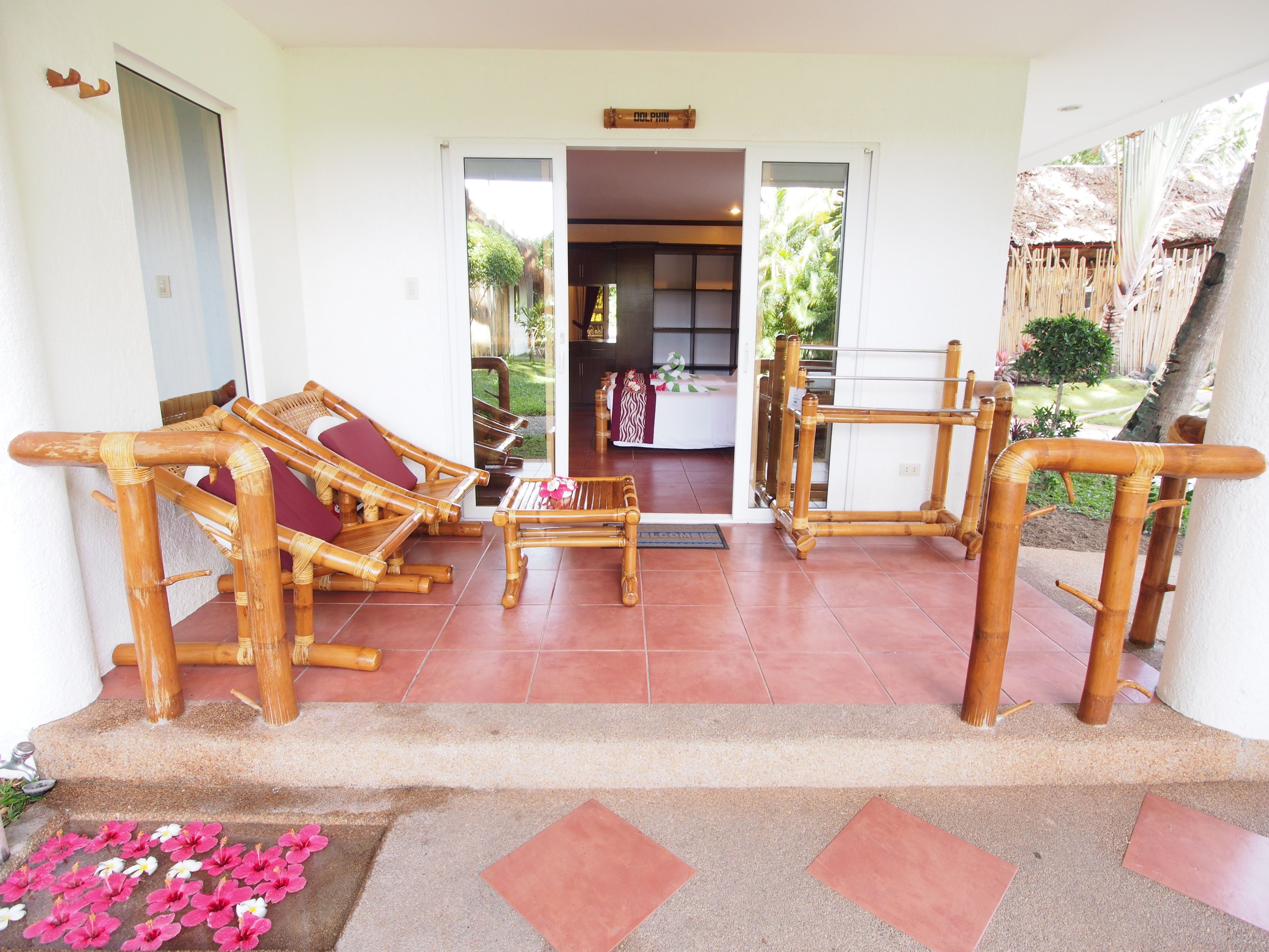 A reception area with a wooden reception desk, a sofa, and a chair.