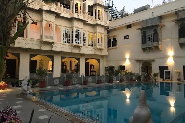 Outdoor pool, open 9:00 AM to 7:00 PM, pool umbrellas