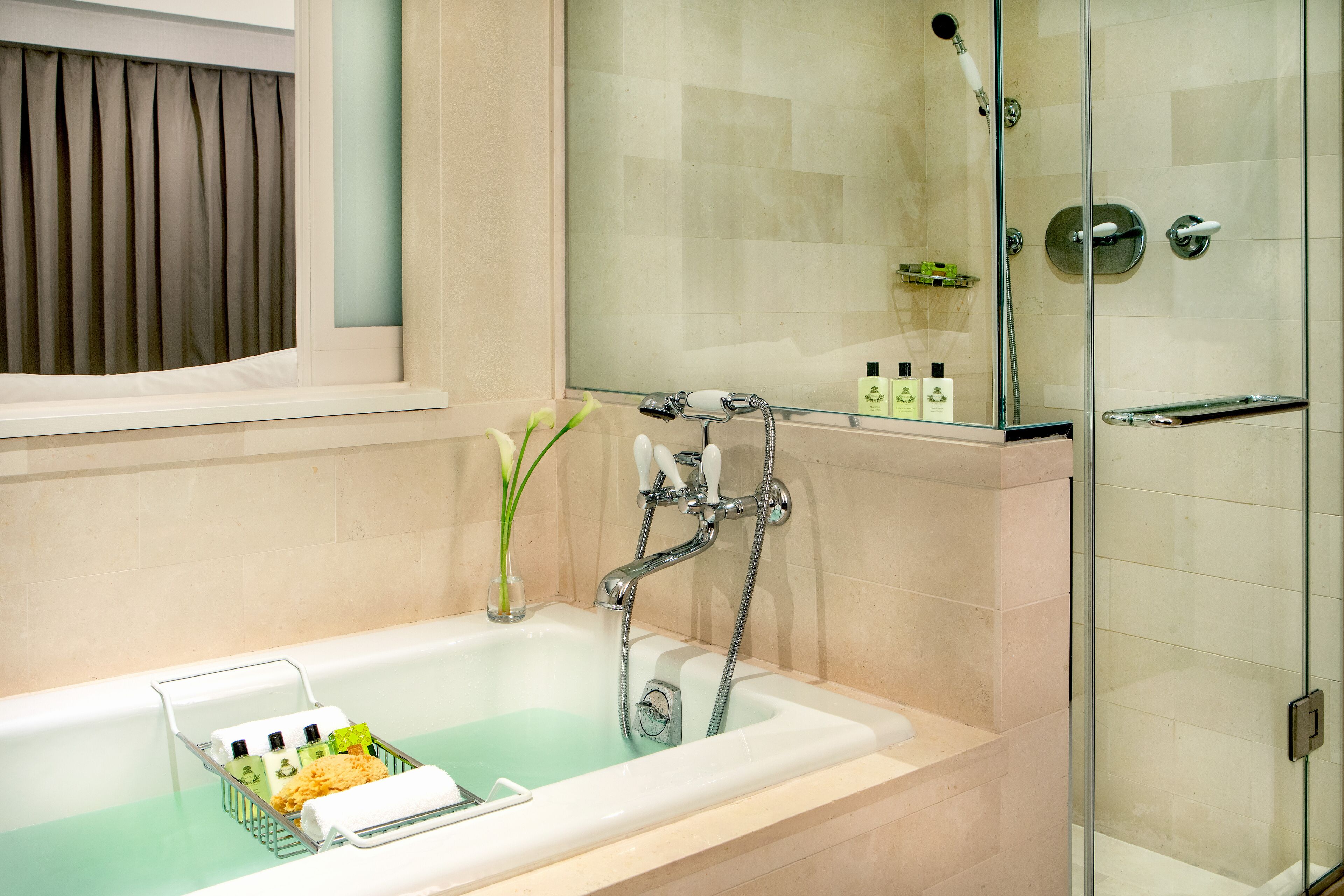 A bathroom with a bathtub, shower, and glass-enclosed shower area.