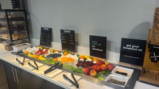 A breakfast buffet with various fruits, vegetables, and bread options. - Holiday Inn Atlanta/Roswell by IHG (Roswell)