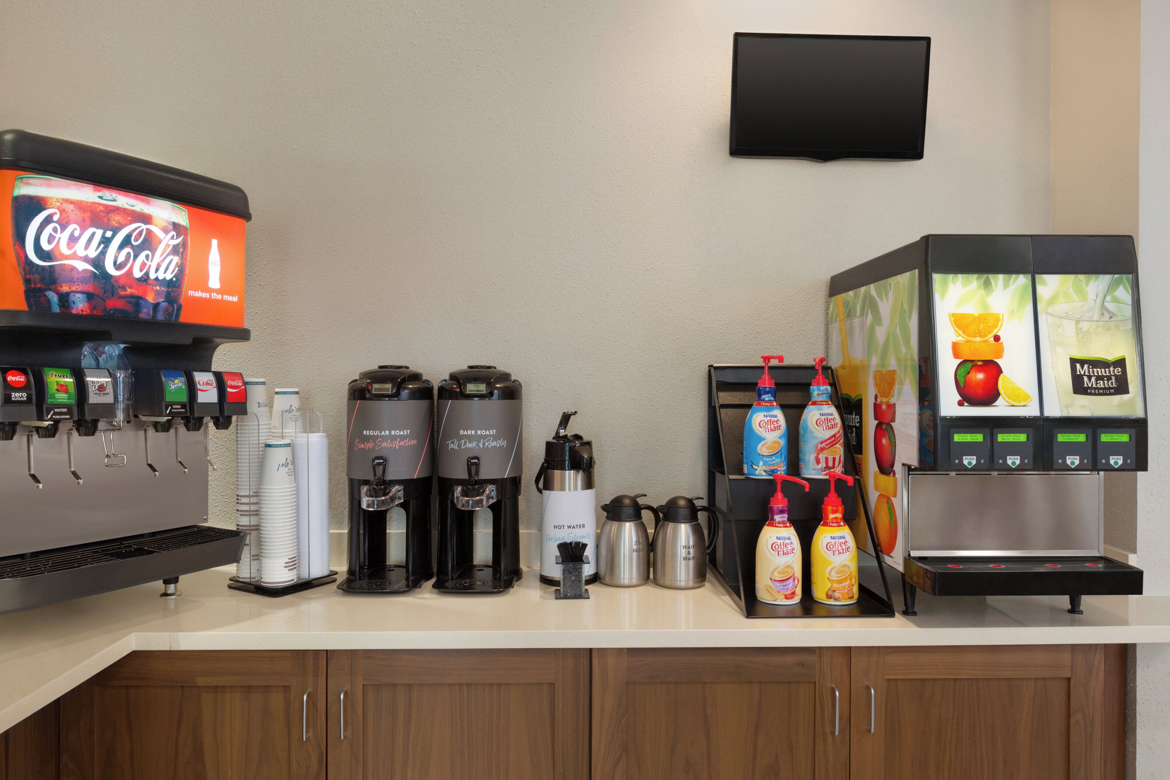 A coffee station with various drink options including hot water, coffee, and tea.