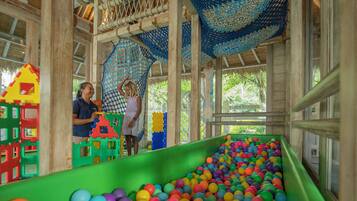 A play area with a ball pit and colorful play structures.