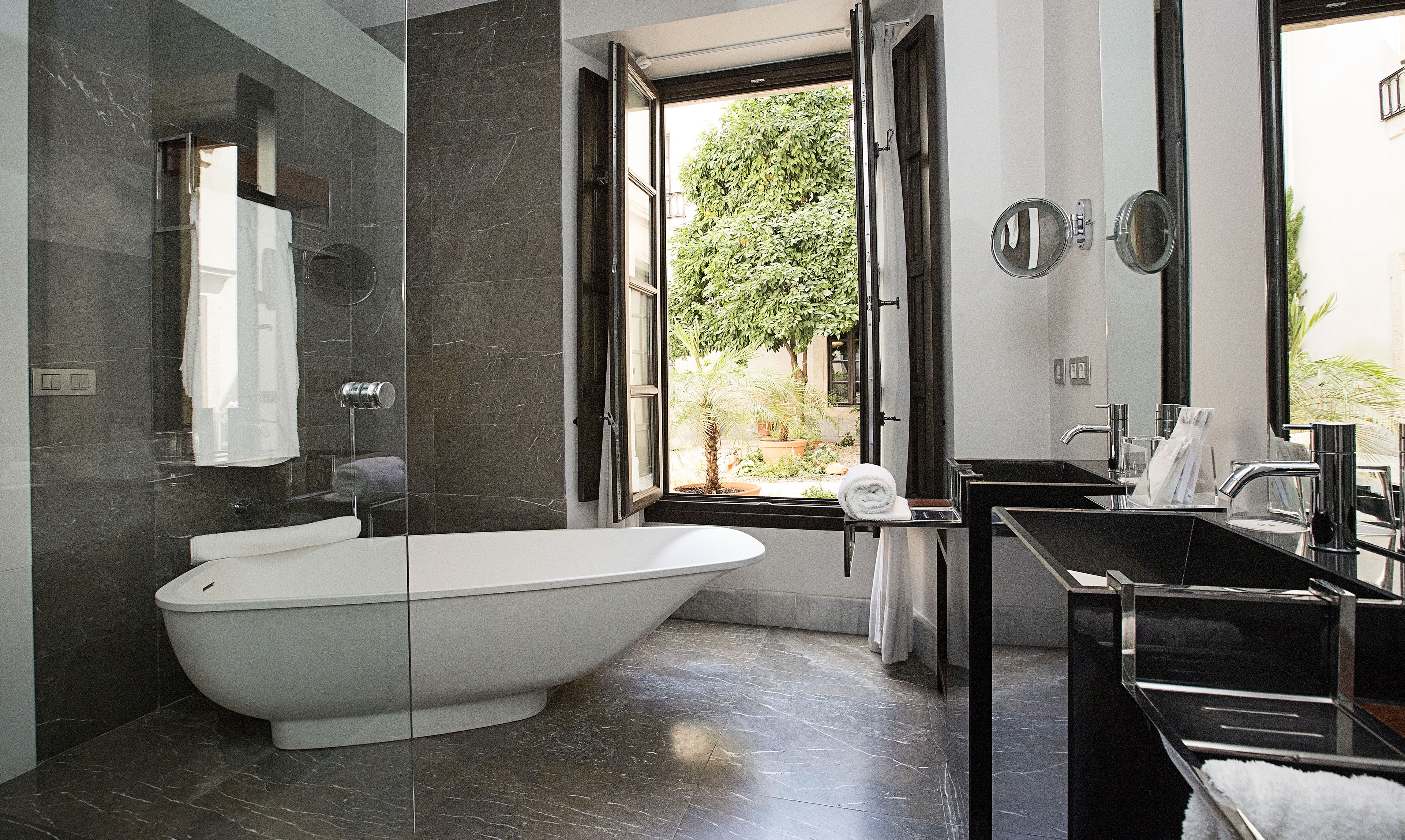 separate bathtub and shower, rainfall showerhead, designer toiletries