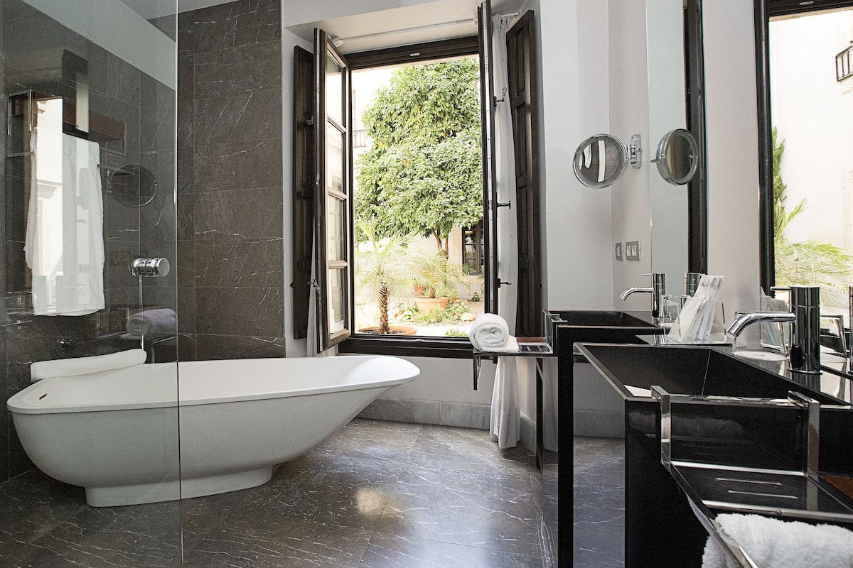 separate bathtub and shower, rainfall showerhead, designer toiletries