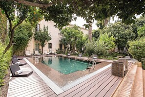 Outdoor pool, open 10:00 AM to 8:00 PM, pool umbrellas, pool loungers