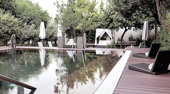 Outdoor pool, open 10:00 AM to 8:00 PM, pool umbrellas, pool loungers