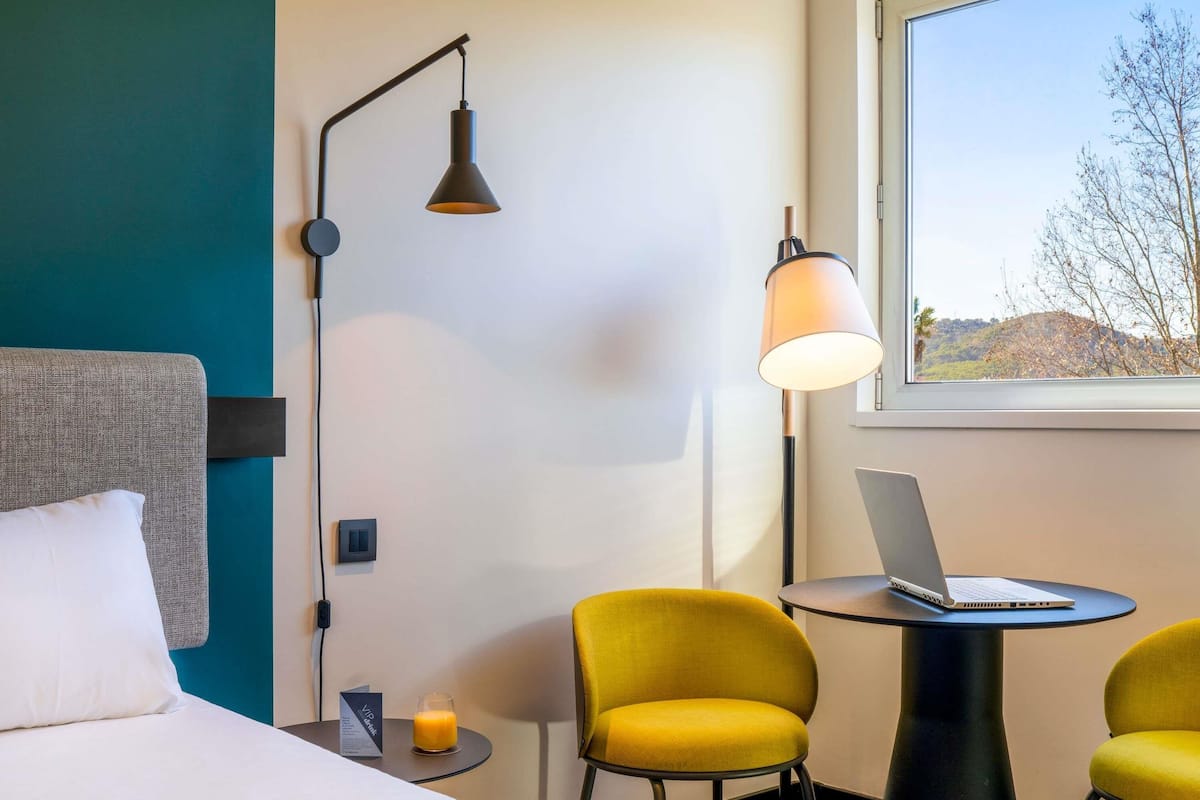 Hypo-allergenic bedding, down duvets, desk, laptop workspace