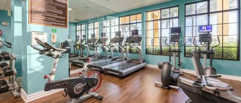 A fitness center with treadmills, elliptical machines, and weight equipment.