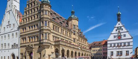 A historic building with a prominent tower and a large arched entrance.