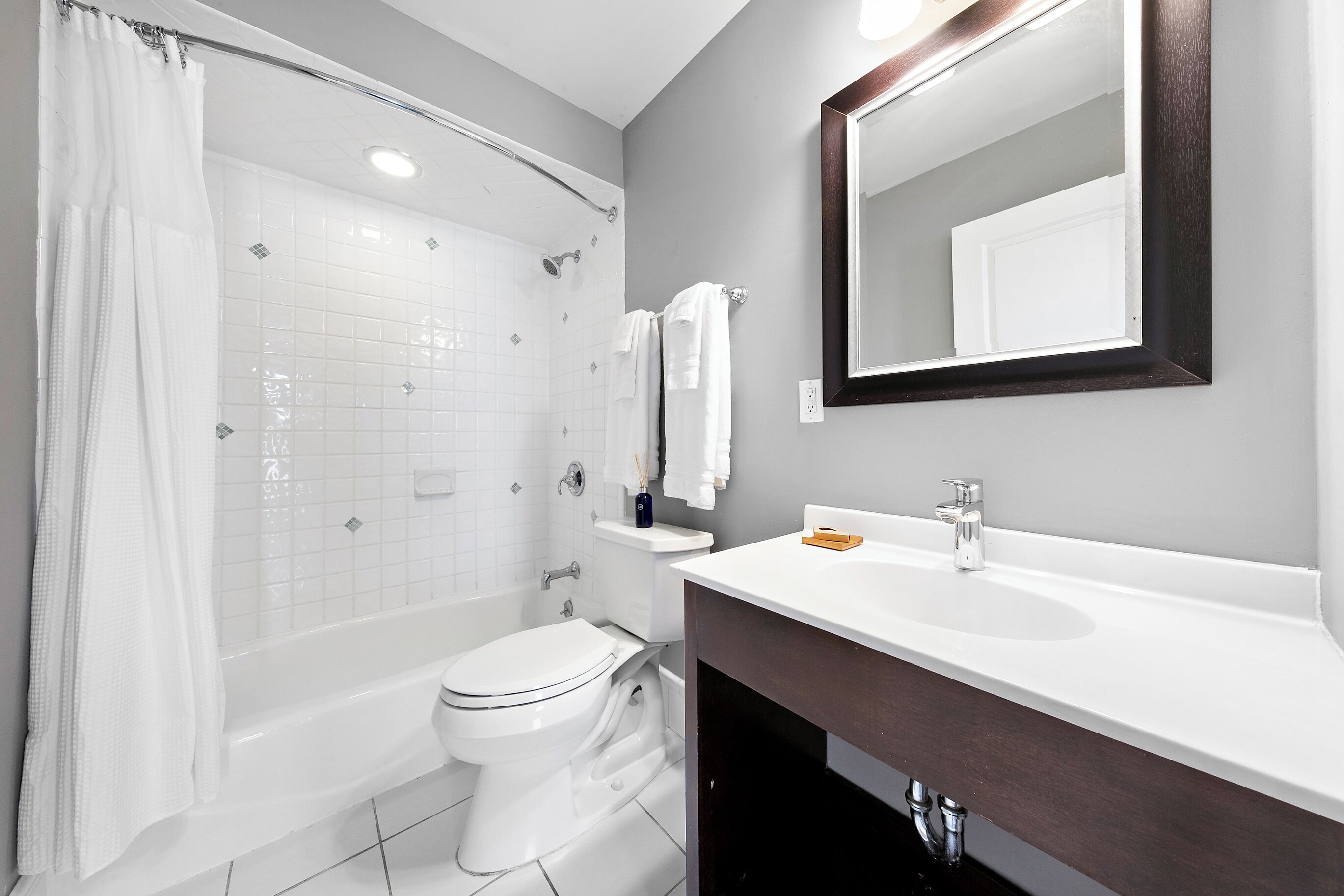A bathroom with a bathtub, toilet, and sink.