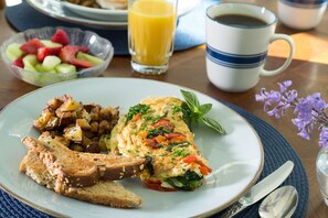 A breakfast plate with toast, scrambled eggs, and potatoes.