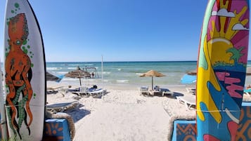 On the beach, sun loungers, beach umbrellas, beach volleyball
