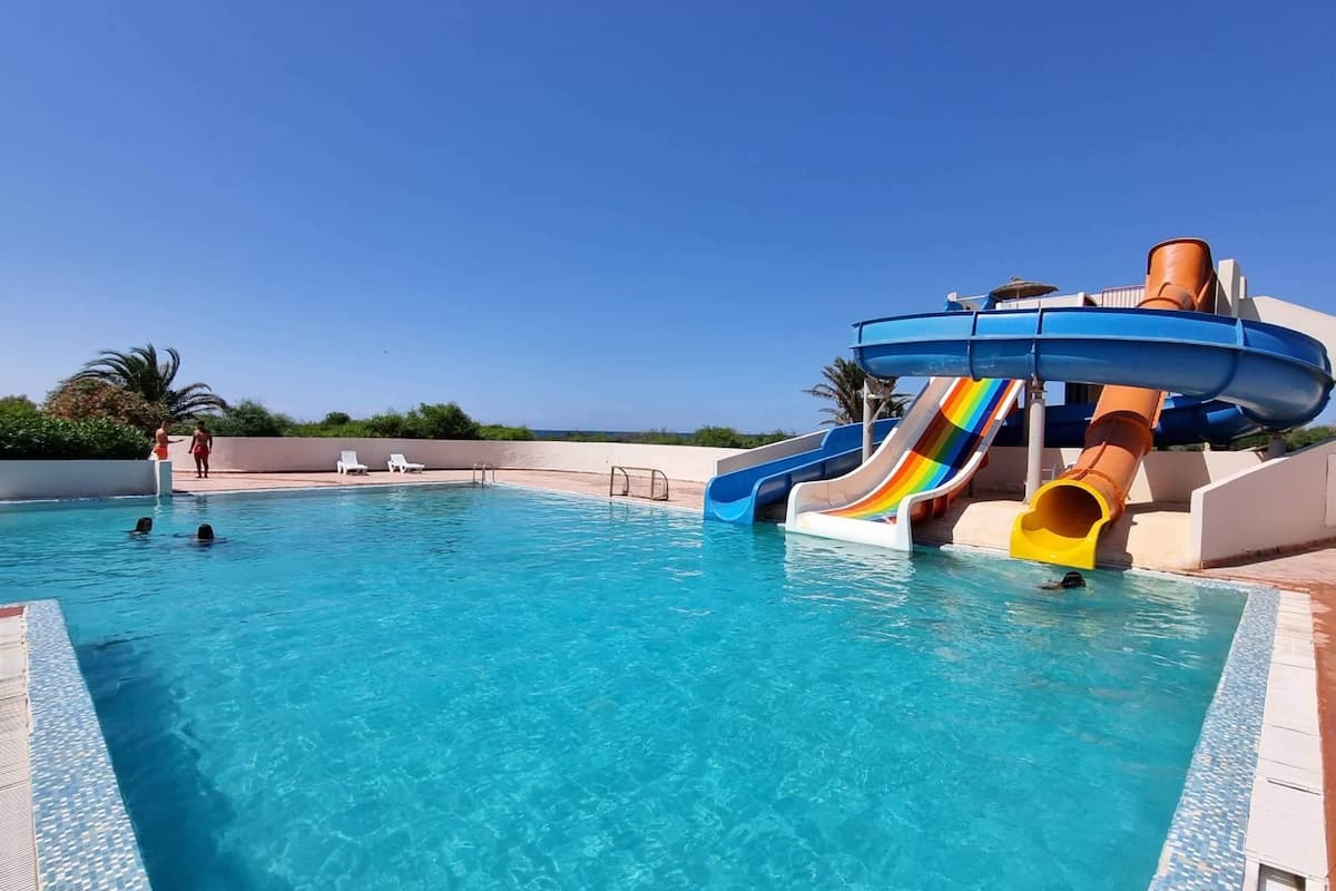 indoor pool, outdoor pool, pool umbrellas, pool loungers