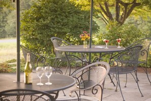 Enjoy al fresco dining in a serene garden setting, surrounded by lush greenery.