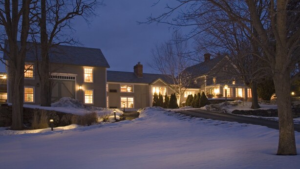 A large, two-story house with a snow-covered driveway and surrounding trees. - Chesterfield Inn (West Chesterfield)
