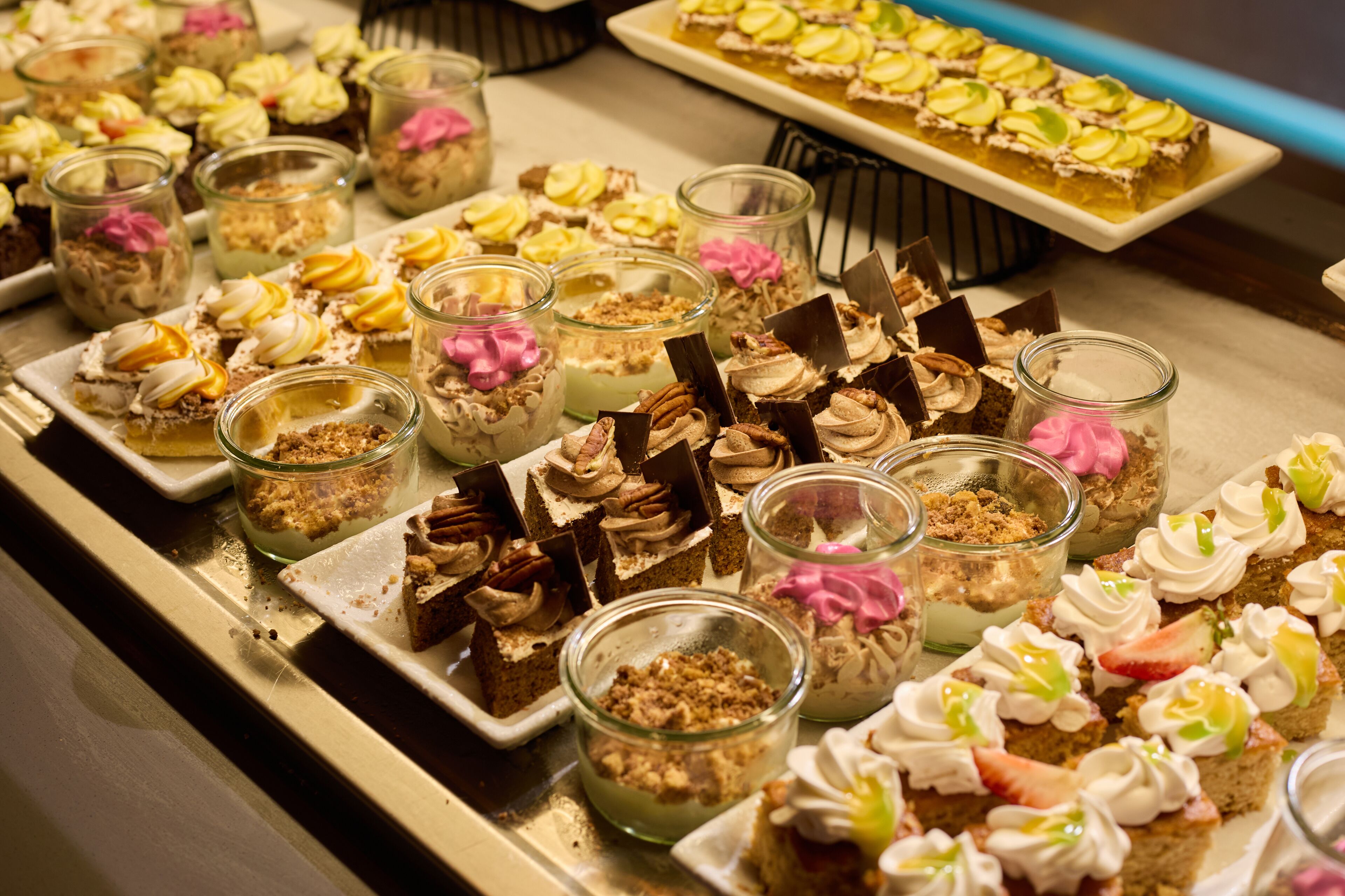 Diverses postres disposades sobre una taula de buffet.