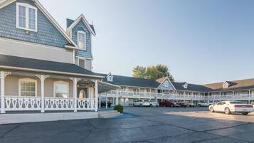 Classic motel with attached buildings and a spacious parking area.