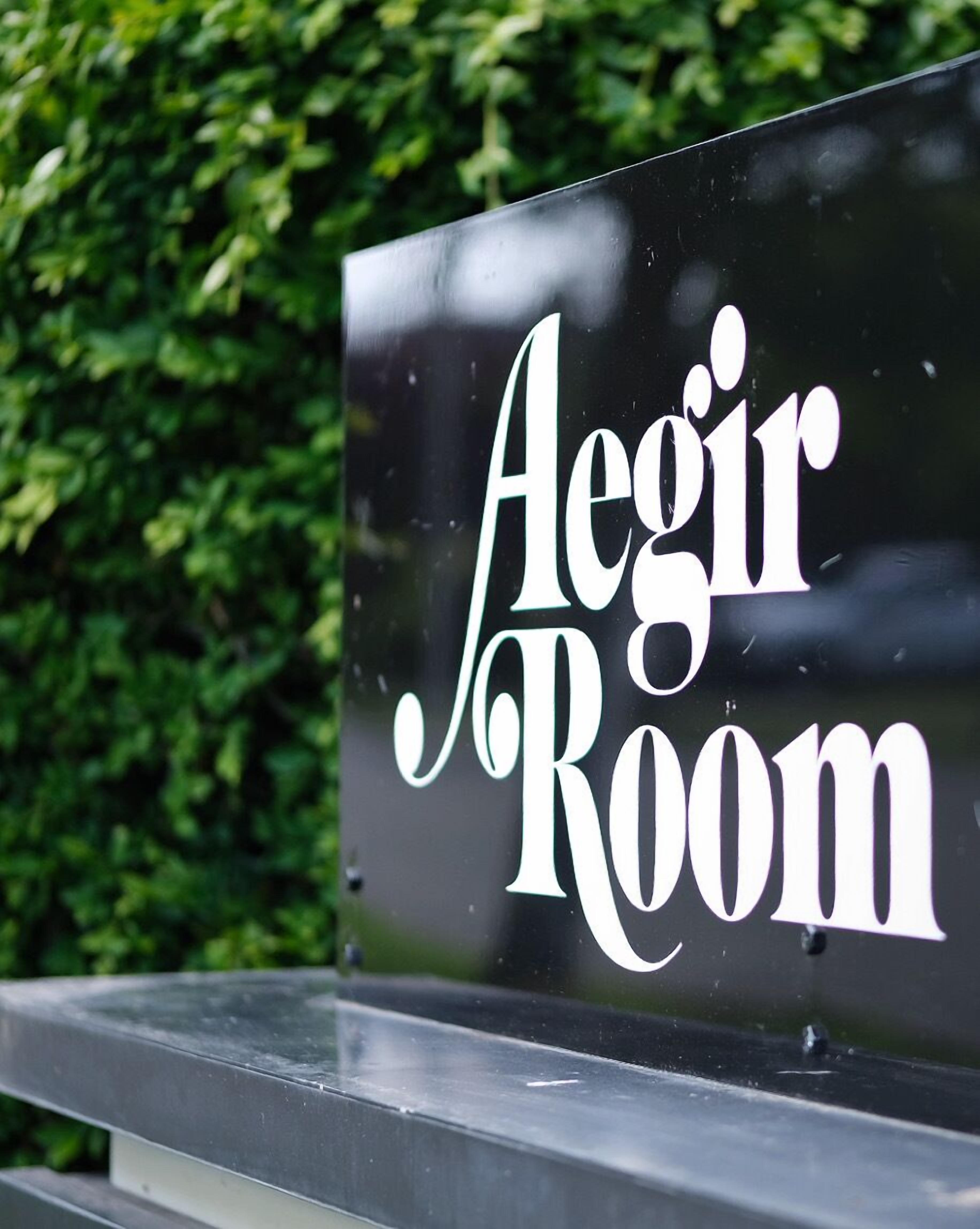 A sign with the text "Aegir Room" on a black background.
