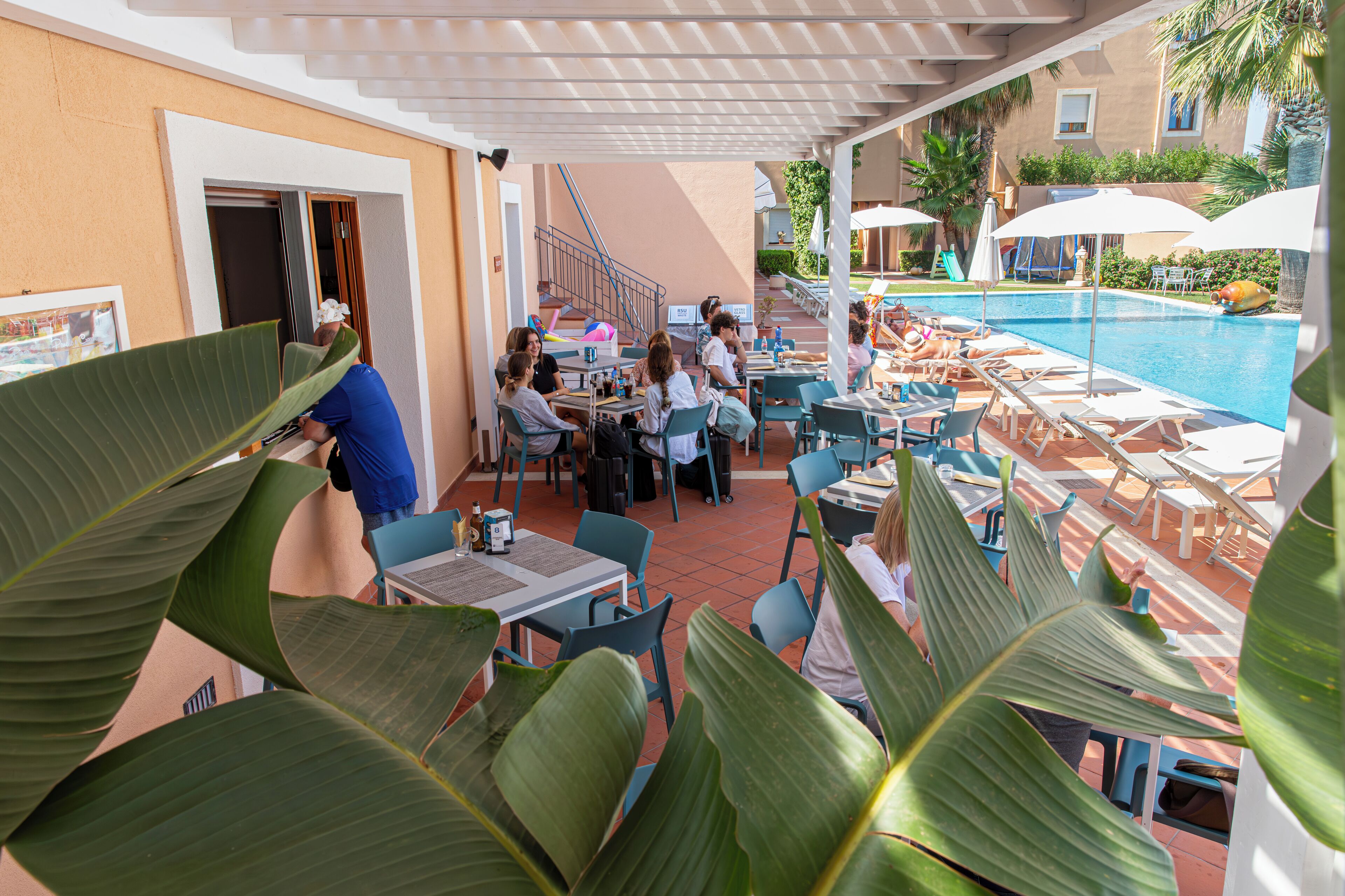 A poolside area with outdoor seating and a pool.