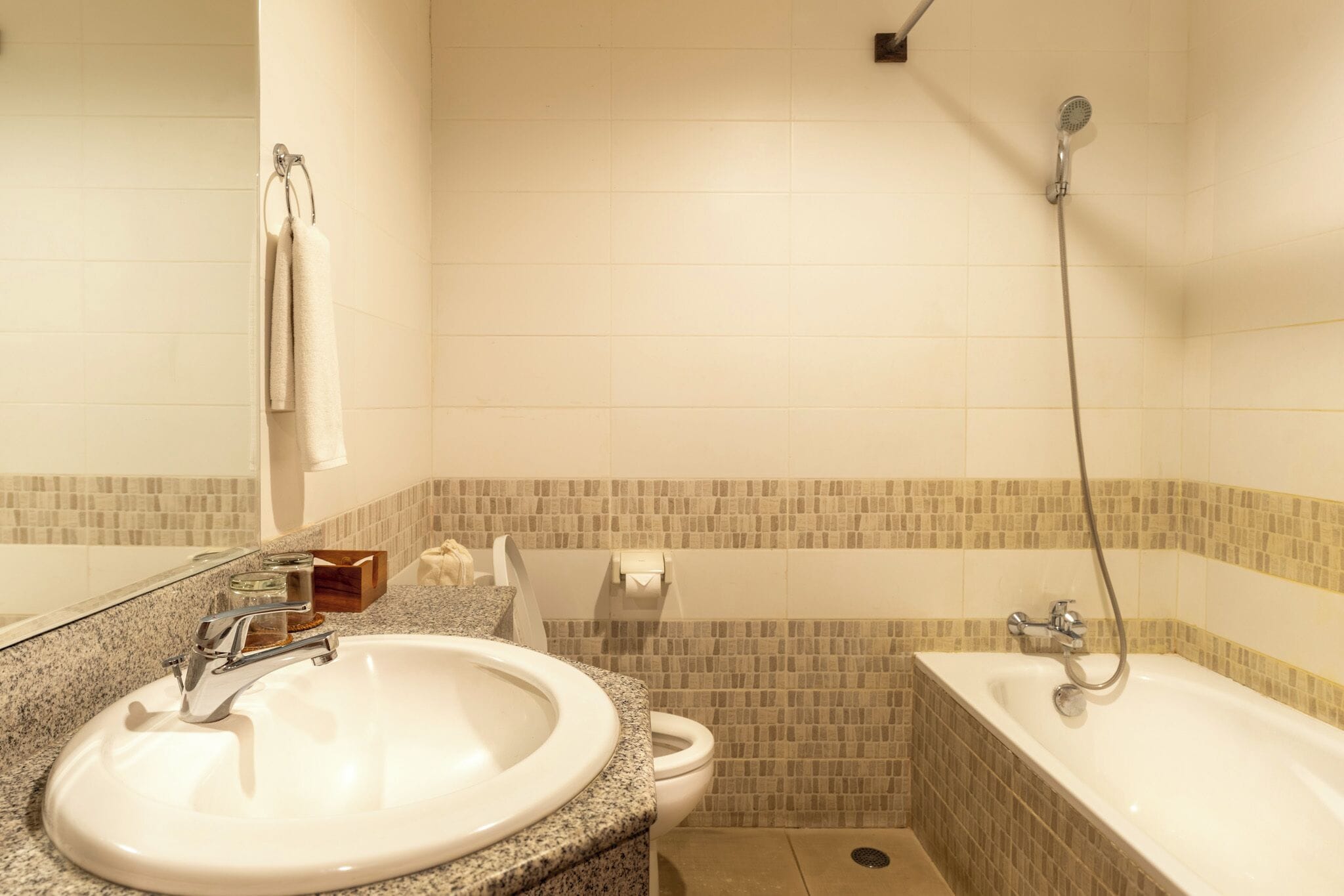 A bathroom with a sink, toilet, and bathtub.