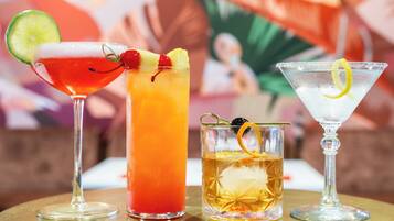 Three different cocktails on a table with a blurred background.