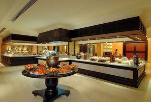 A buffet setup with various food items and a central serving table.