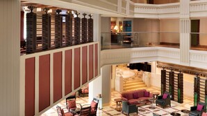A multi-level hotel lobby with a central seating area, multiple balconies, and a grand staircase. - Hyderabad Marriott Hotel & Convention Centre (Hyderabad)