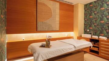 Relax in a cozy retreat with a large bed, bedside table, and bathroom.