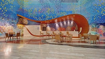 A reception area with a curved wooden desk, multiple chairs, and a tiled floor.