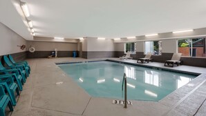 An indoor swimming pool with clear water, surrounded by lounge chairs and a tiled deck. - Country Inn & Suites by Radisson, Augusta at I-20, GA (Augusta)