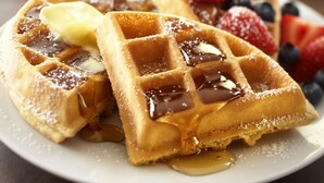 A plate of waffles topped with syrup, butter, and fresh berries. - Country Inn & Suites by Radisson, Augusta at I-20, GA (Augusta)