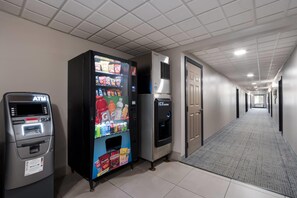 A hallway with an ATM, a vending machine, and an ice dispenser. - Country Inn & Suites by Radisson, Augusta at I-20, GA (Augusta)
