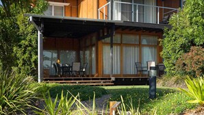 A modern two-story house with a covered porch, large windows, and a well-maintained garden. - The Sebel Twin Waters (Twin Waters)
