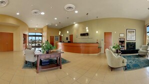 A spacious lobby with a reception desk, seating area, and a fireplace. - DoubleTree by Hilton Napa Valley - American Canyon (American Canyon)
