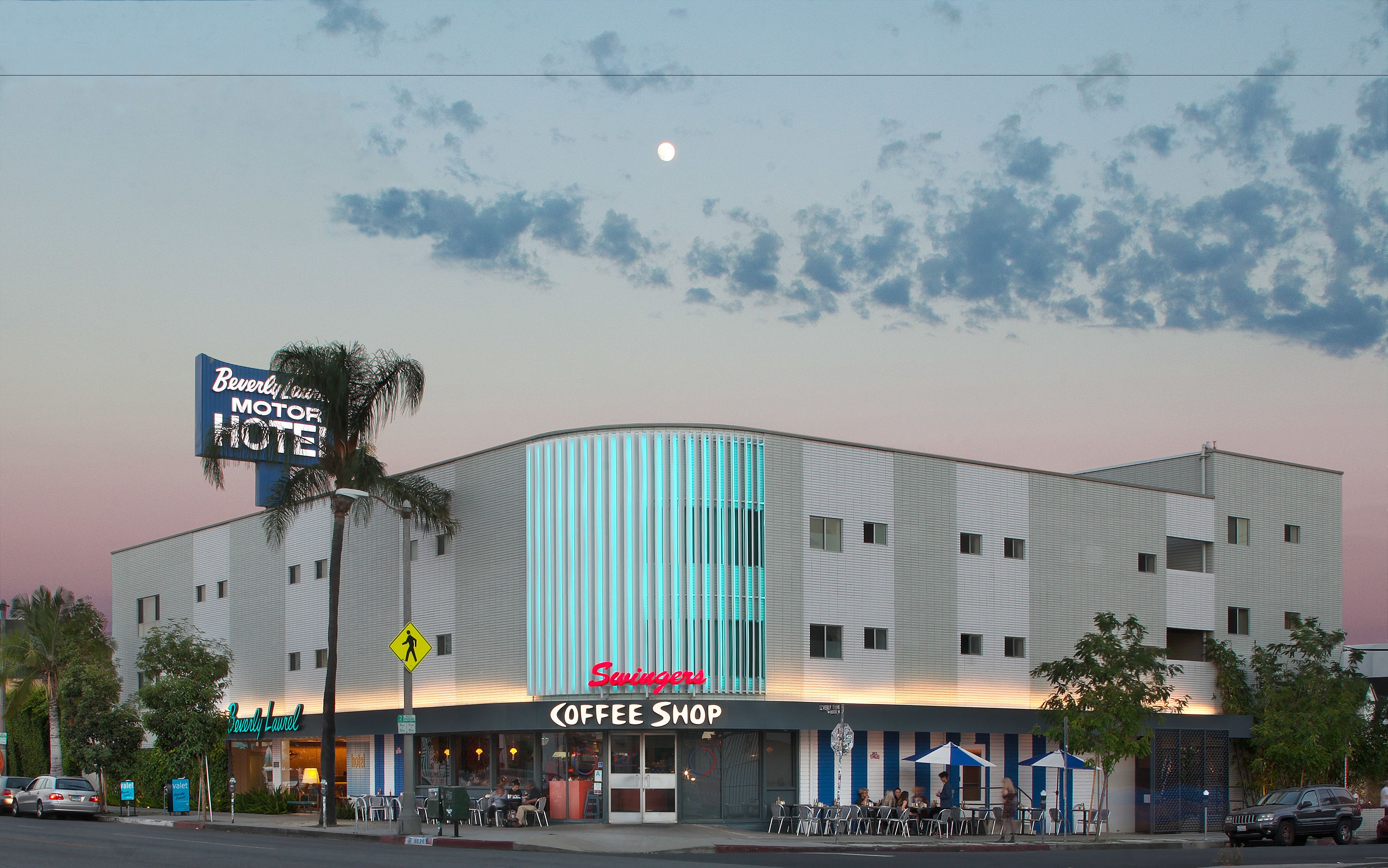 A modern building with a coffee shop and a Beverly Motel sign.
