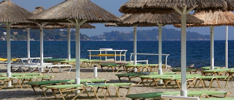 Nära stranden, vit sandstrand, solstolar och strandbarer