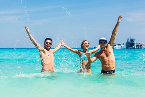 On the beach, sun loungers, beach umbrellas, beach towels