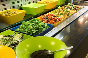 A buffet with various dishes in colorful bowls. - Club Hotel Eilat (Eilat)