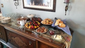 A breakfast buffet with various food items and a coffee station. - The Parks Inn Bed and Breakfast (Lemon Cove)
