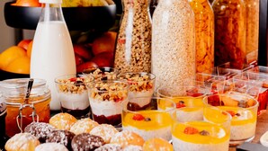 A buffet with various food items including fruits, cereals, and desserts. - Hotel Ascot Premium (Kraków)