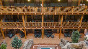 A multi-level hotel with a pool area, outdoor seating, and a view of the surrounding landscape. - C'mon Inn Bozeman (Bozeman)