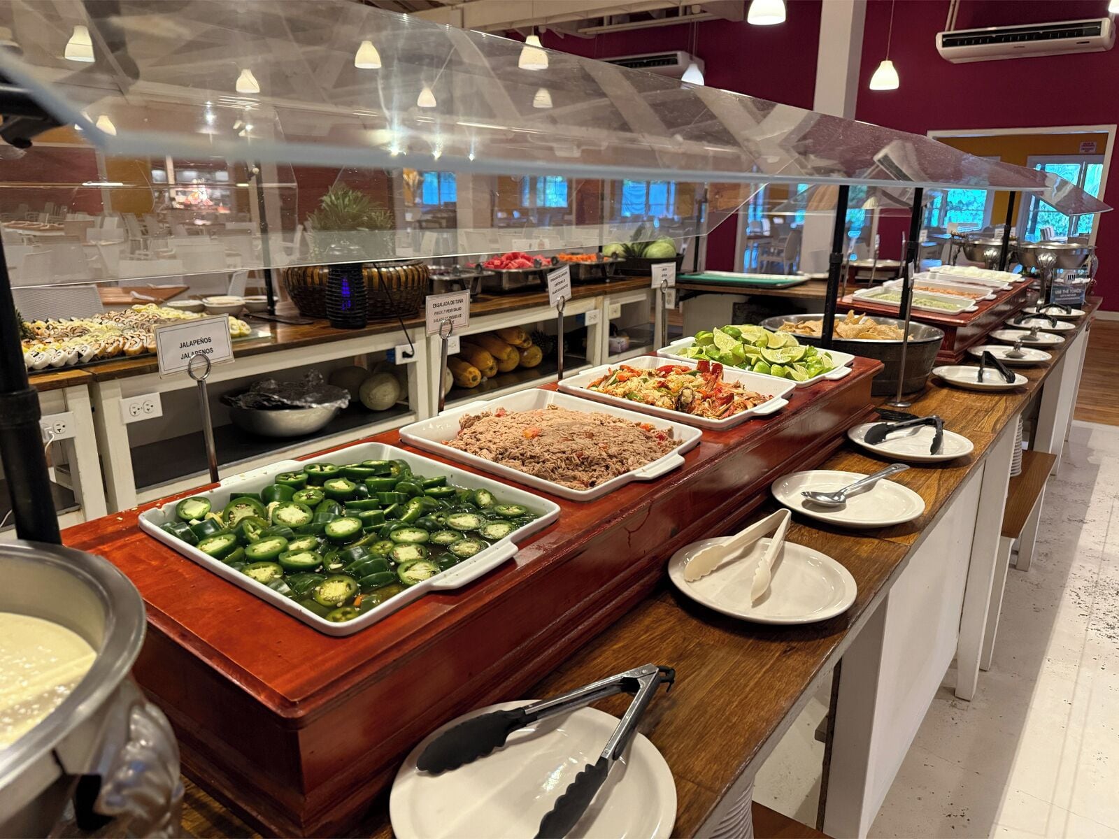 Un bufé con diversas opciones de comida, como ensaladas, carnes y verduras.