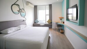 A modern hotel room with a bed, a desk, a TV, and a large window with curtains. - Liberty Hotel Saigon Parkview (Ho Chi Minh City)
