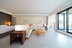 A modern hotel room with a bed, sofa, coffee table, and a large window offering a view. - Hyatt Regency Hakone Resort and Spa (Hakone)