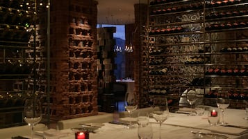 A restaurant with a brick wall and wine racks.