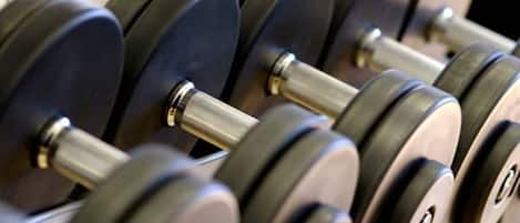 A set of black dumbbells with silver handles and weight markings.