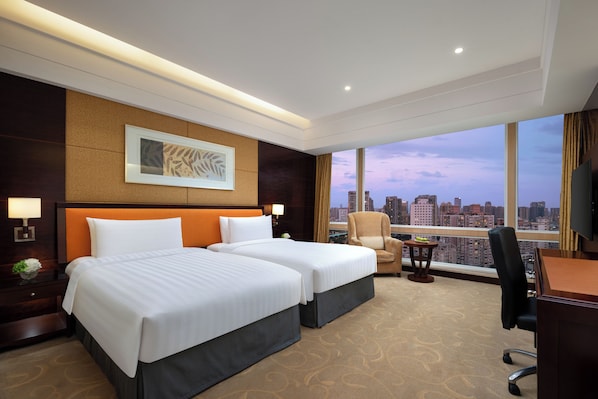 A hotel room with two beds, a desk, a chair, and a large window offering a city view. - Shangri-La Chengdu (Chengdu)