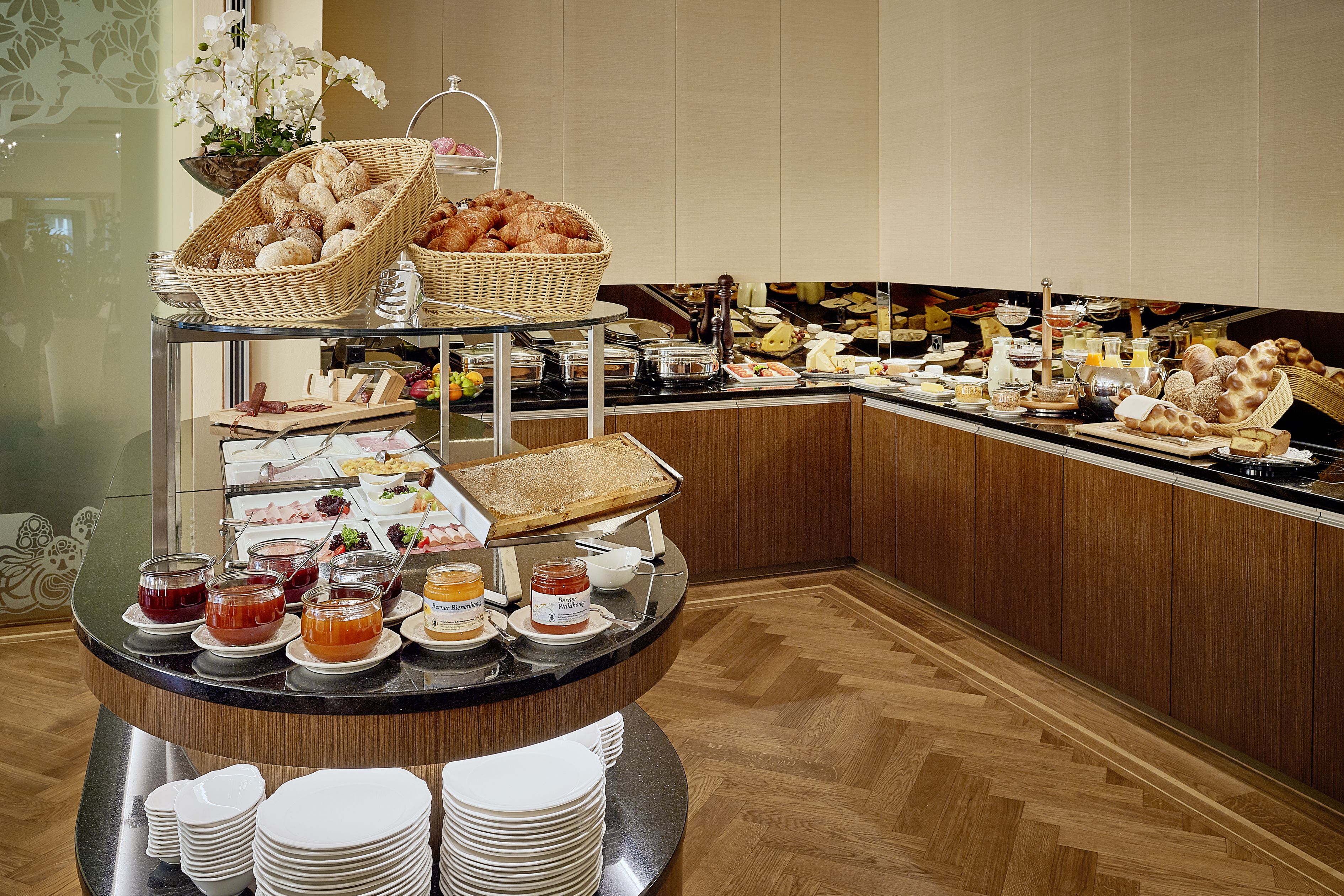 A buffet setup with various food items and condiments.