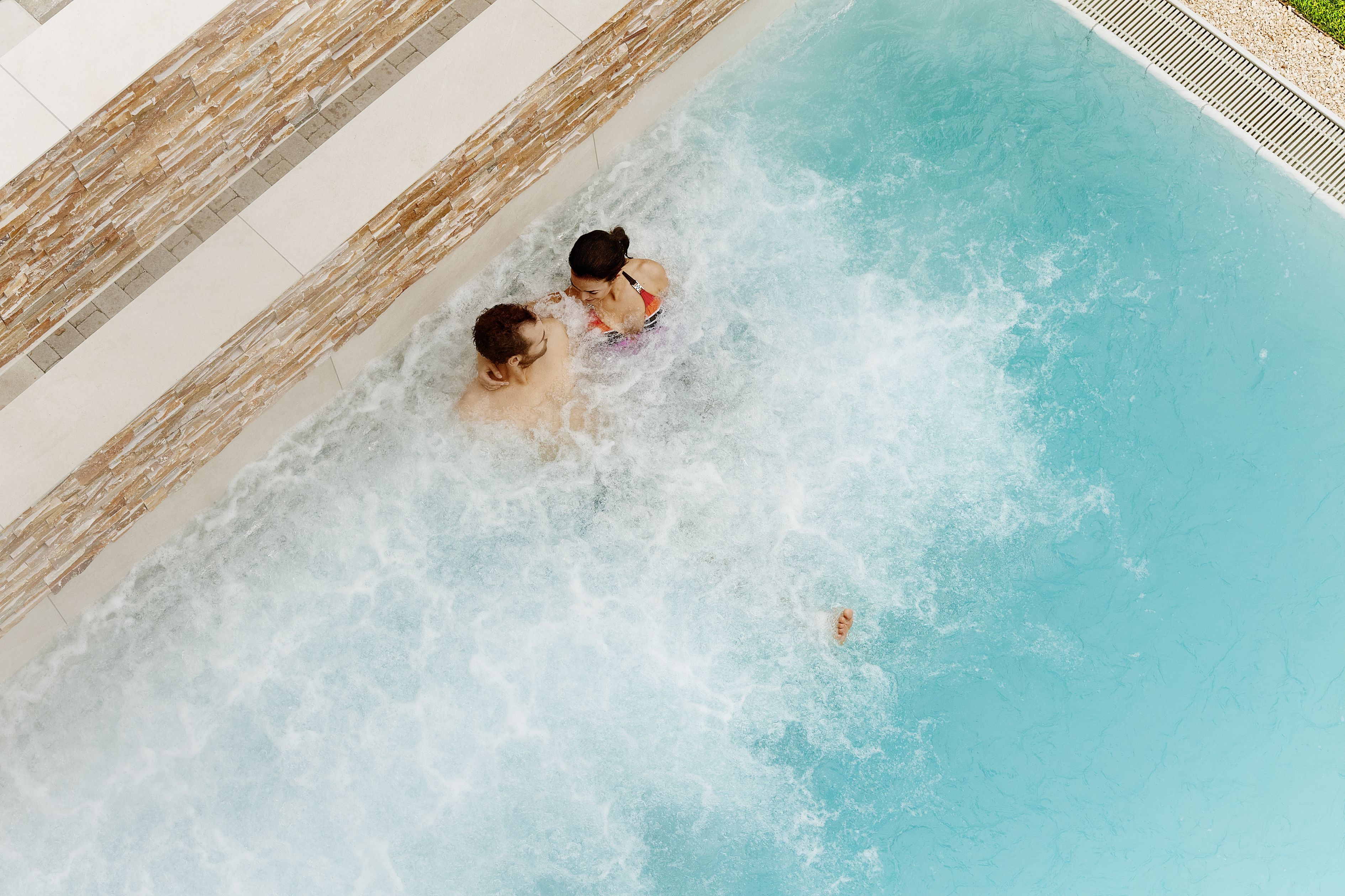 Ein Schwimmbecken mit zwei Personen im Wasser.