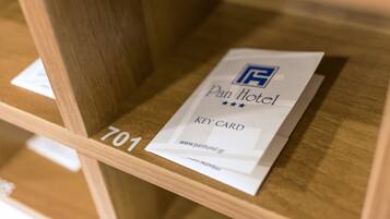 A key card for Pan Hotel with the number 701 visible.